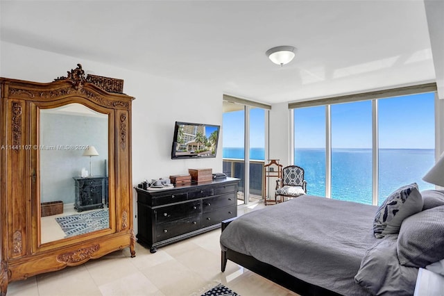 tiled bedroom featuring a wall of windows and a water view