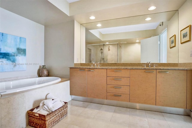 bathroom with double vanity, shower with separate bathtub, and tile floors