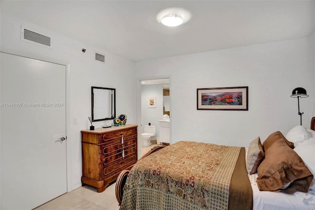 tiled bedroom featuring ensuite bathroom