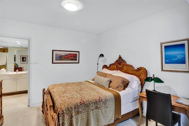 bedroom featuring ensuite bathroom and light tile flooring