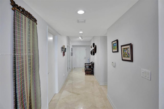 corridor featuring light tile flooring