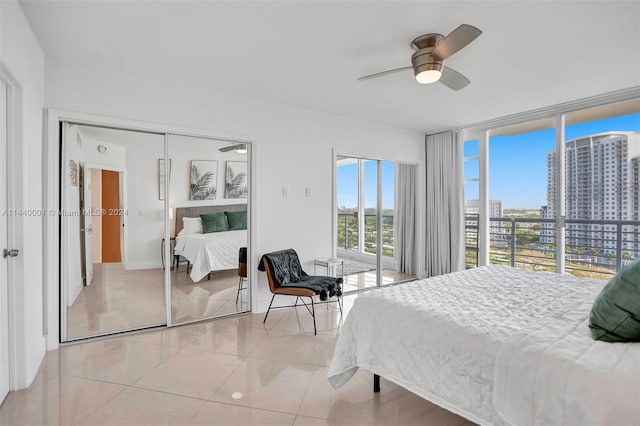 bedroom featuring light tile floors, a closet, and ceiling fan