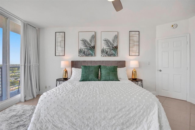 bedroom featuring light tile floors and ceiling fan