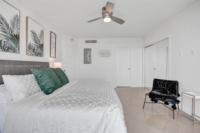 bedroom with ceiling fan, a closet, and light tile floors