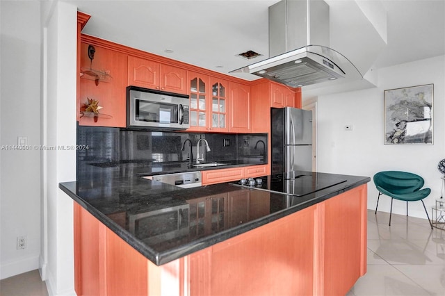 kitchen with appliances with stainless steel finishes, tasteful backsplash, island range hood, sink, and light tile flooring