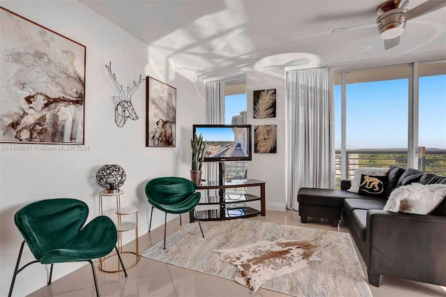 living area with ceiling fan, light tile floors, and a wealth of natural light