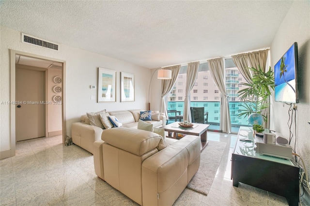 tiled living room featuring a textured ceiling