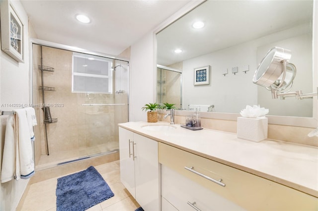 bathroom with an enclosed shower, tile floors, and large vanity