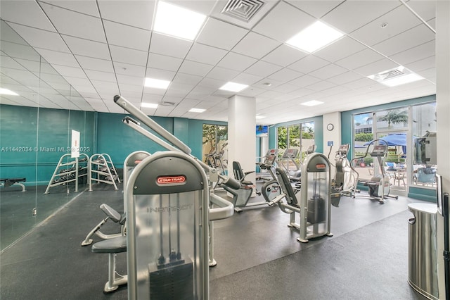 exercise room featuring a drop ceiling