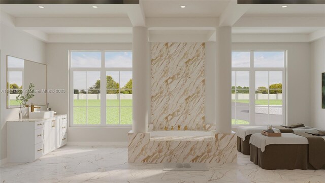 bathroom with vanity, a bathing tub, and beamed ceiling