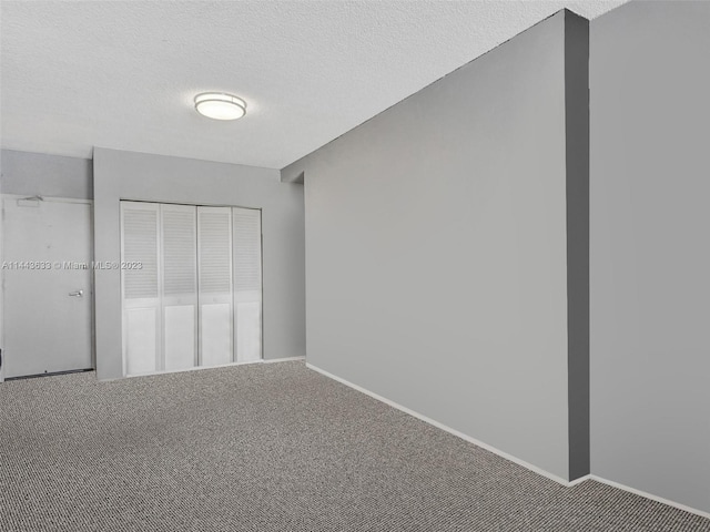 unfurnished bedroom featuring a closet, a textured ceiling, and carpet floors