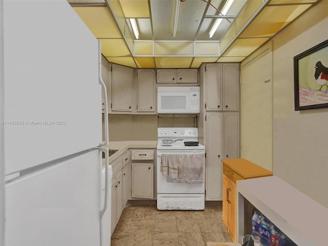 kitchen featuring white appliances and light tile flooring