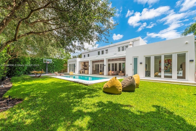 rear view of house with a patio, a yard, and french doors