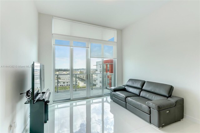 living room with light tile flooring and expansive windows