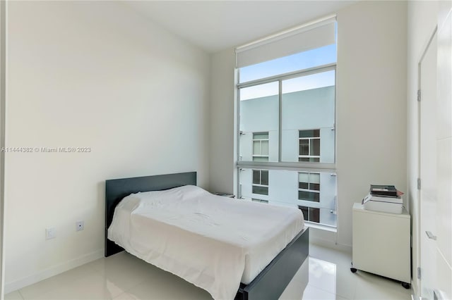 tiled bedroom with floor to ceiling windows