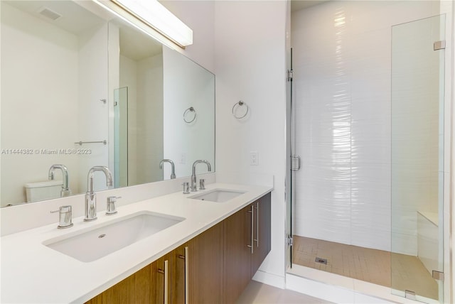 bathroom featuring an enclosed shower, tile floors, dual sinks, toilet, and oversized vanity