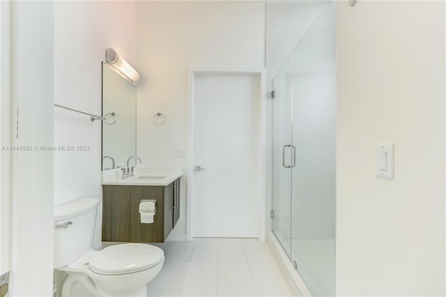 bathroom featuring walk in shower, toilet, tile floors, and oversized vanity