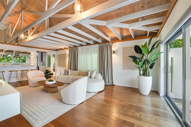 living room featuring beam ceiling and light wood-type flooring