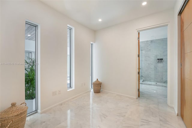 hall featuring light tile patterned floors