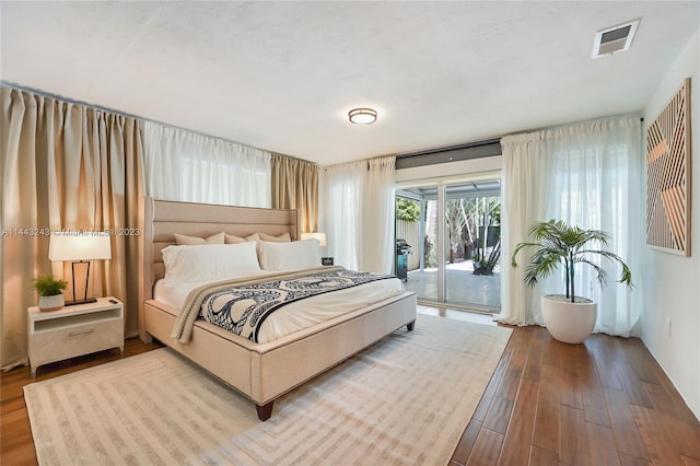 bedroom featuring access to outside and wood-type flooring