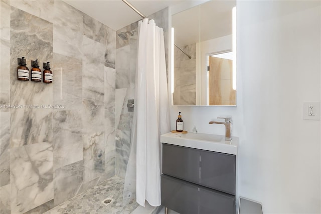 bathroom featuring curtained shower and vanity