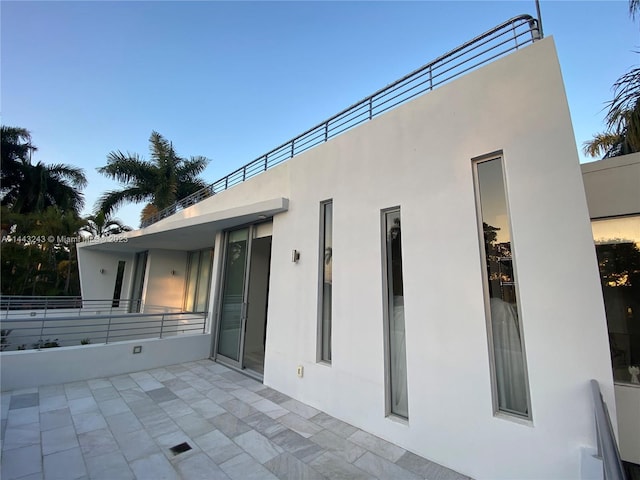 rear view of property with a balcony