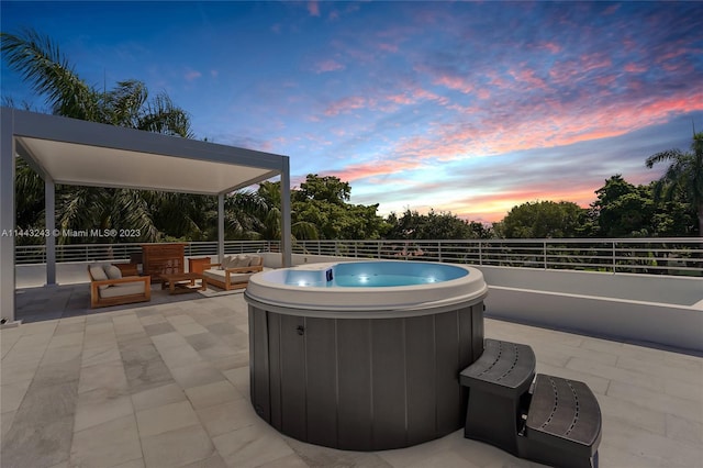 pool at dusk featuring a hot tub and a patio area