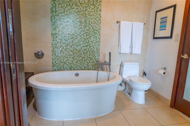 bathroom with tile walls, toilet, a washtub, and tile flooring