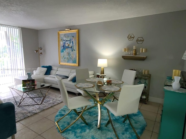 tiled dining room with a textured ceiling