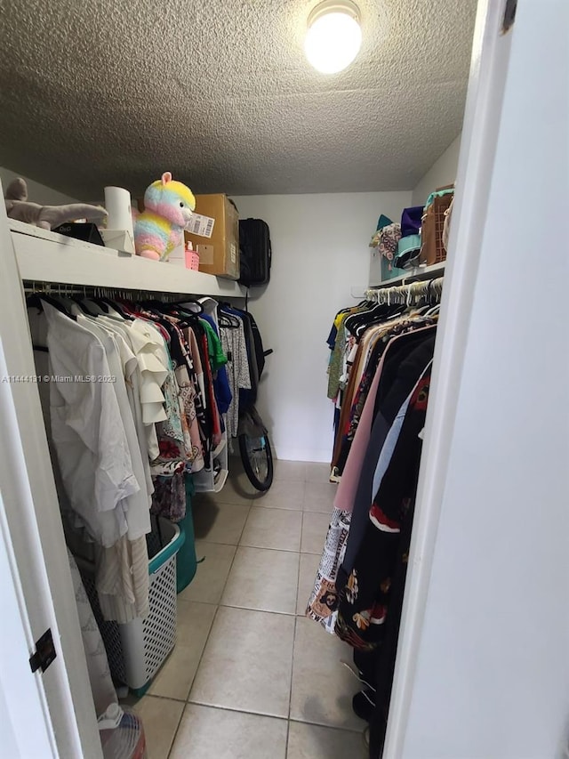 spacious closet featuring light tile floors