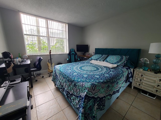 tiled bedroom featuring a textured ceiling