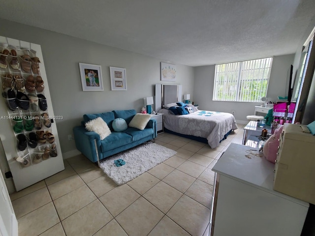 bedroom featuring a textured ceiling and light tile floors