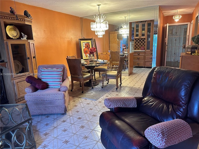 tiled living room with a notable chandelier and a textured ceiling