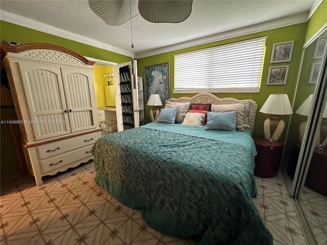 bedroom featuring ensuite bathroom, ornamental molding, ceiling fan, and a textured ceiling