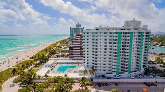 birds eye view of property with a water view and a beach view