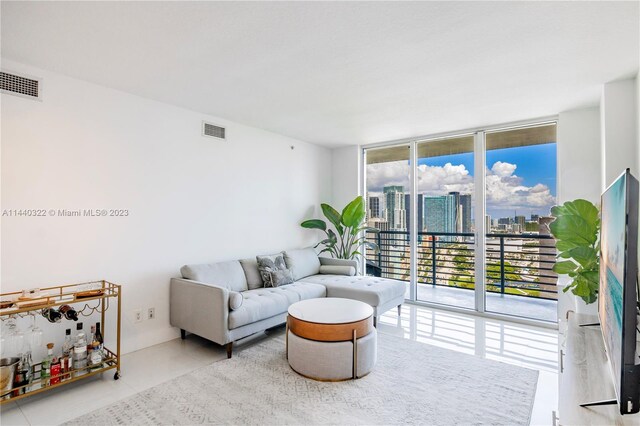 tiled living room with floor to ceiling windows and a healthy amount of sunlight