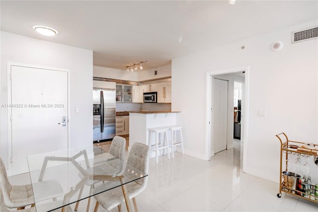 tiled dining space with rail lighting