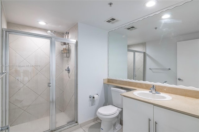 bathroom with toilet, tile floors, a shower with shower door, and large vanity