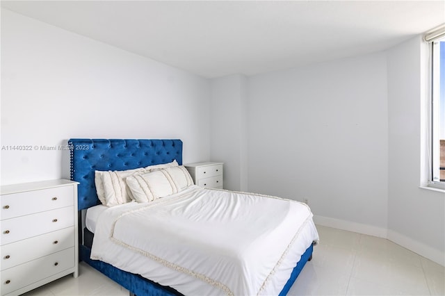 bedroom featuring light tile floors