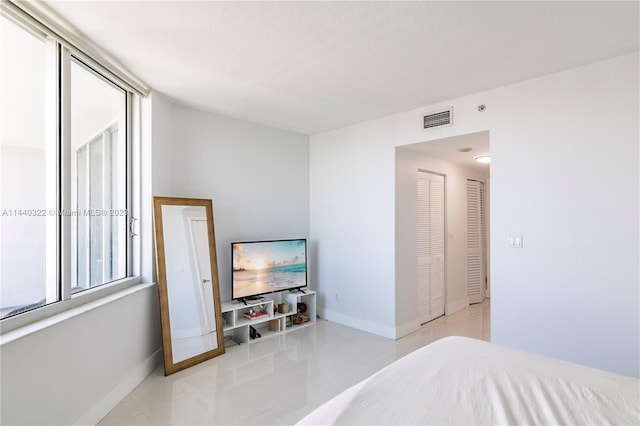 bedroom featuring light tile floors