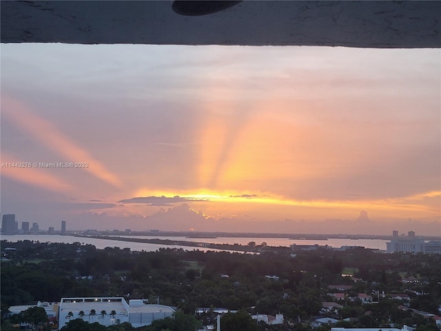 aerial view at dusk with a water view