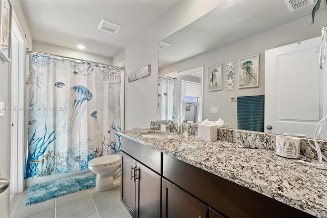 bathroom featuring tile flooring, large vanity, and toilet