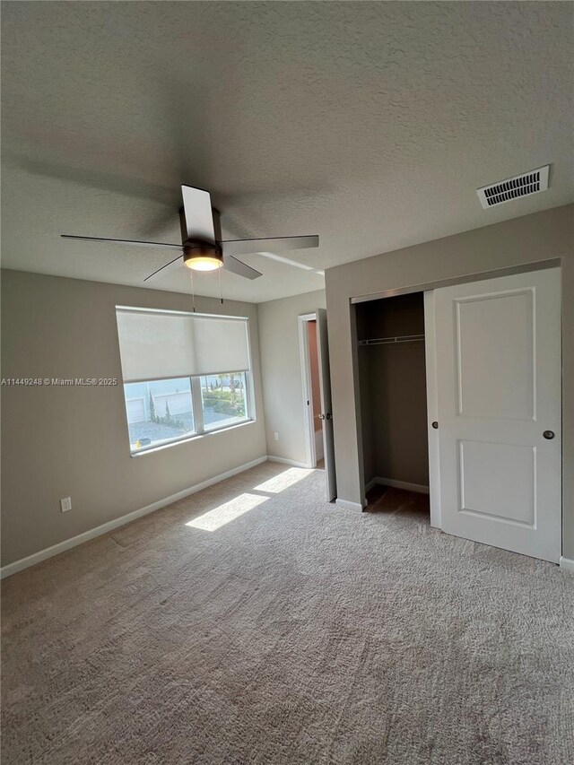 sitting room featuring light carpet and a textured ceiling