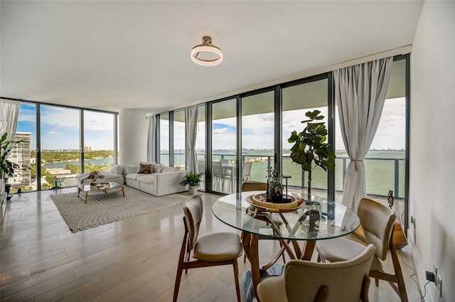 sunroom / solarium featuring a water view