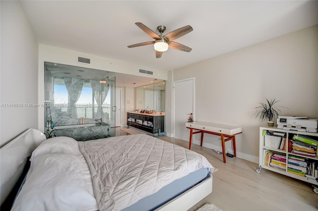 bedroom with ceiling fan and light hardwood / wood-style floors