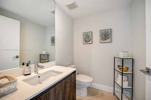 bathroom featuring toilet and vanity