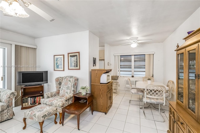 living area featuring a wealth of natural light, ceiling fan, and light tile flooring