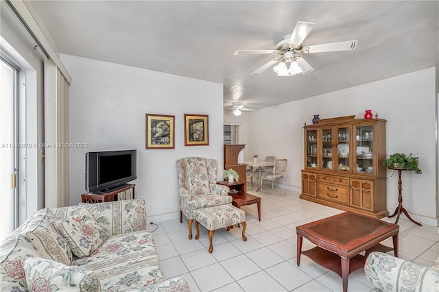 tiled living room with ceiling fan