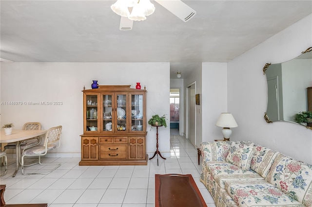 living room featuring ceiling fan and light tile flooring