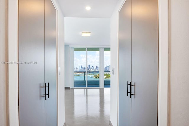 hall featuring expansive windows and concrete floors